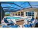 Beautiful screened pool area with outdoor seating and a picturesque view at 218 Pesaro Dr, North Venice, FL 34275