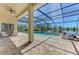 Private screened pool area with a hot tub and lounge chairs, overlooking a scenic pond at 218 Pesaro Dr, North Venice, FL 34275