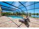 Relaxing pool area with lounge chairs and a beautiful view of the surrounding landscape at 218 Pesaro Dr, North Venice, FL 34275