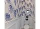 Charming powder room featuring custom wall paper, decorative mirror and white trim at 218 Pesaro Dr, North Venice, FL 34275