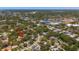 Bird's-eye view of a property nestled in a neighborhood near a baseball stadium and surrounded by lush trees and greenery at 219 Park S Cir, Dunedin, FL 34698