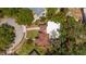 Aerial view of a property showcasing its layout, including the house, garage, driveway, and surrounding landscaping at 219 Park S Cir, Dunedin, FL 34698