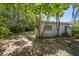 Trees surround the backyard with access to a pathway and lush landscaping at 219 Park S Cir, Dunedin, FL 34698