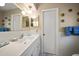 Neat bathroom featuring a single sink vanity, built-in storage, and vintage decor at 219 Park S Cir, Dunedin, FL 34698