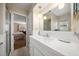 Simple bathroom with a single sink vanity, tile accents, and an adjacent bedroom at 219 Park S Cir, Dunedin, FL 34698