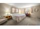 Relaxing bedroom bathed in soft light, featuring a comfortable bed, a classic desk, and bright drapes at 219 Park S Cir, Dunedin, FL 34698