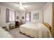Cozy bedroom with a four-poster bed, desk, and soft purple accents at 219 Park S Cir, Dunedin, FL 34698