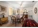 Formal dining room with vintage furniture, including a wooden table, rug and decorative mirror at 219 Park S Cir, Dunedin, FL 34698