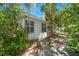 Exterior back entrance to home featuring a white door and well-lit with natural sunlight at 219 Park S Cir, Dunedin, FL 34698