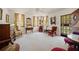 Bright living room with floral curtains, an antique mirror, and a mix of classic furniture, creating a warm ambiance at 219 Park S Cir, Dunedin, FL 34698