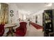 Bright and airy living room featuring a mix of antique furnishings, neutral carpeting, and a view into other rooms at 219 Park S Cir, Dunedin, FL 34698