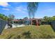A big back yard with an in-ground pool, large patio, and fenced yard at 222 N Clearview Ave, Tampa, FL 33609
