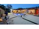 Backyard featuring a pool, lounge area, dining set, and modern outdoor lighting at 222 N Clearview Ave, Tampa, FL 33609
