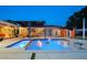 Backyard featuring a pool, lounge area, dining set, and modern outdoor lighting at 222 N Clearview Ave, Tampa, FL 33609