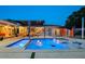 Backyard featuring a pool, lounge area, dining set, and modern outdoor lighting at 222 N Clearview Ave, Tampa, FL 33609