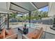 A gorgeous covered patio with a beautiful pool surrounded by lounge furniture at 222 N Clearview Ave, Tampa, FL 33609