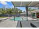 An elegant backyard pool with sun loungers and mature landscaping at 222 N Clearview Ave, Tampa, FL 33609