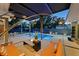 Inviting backyard featuring a pool, lounge area, fire pit, and modern outdoor lighting at 222 N Clearview Ave, Tampa, FL 33609