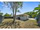 Spacious backyard featuring a well-maintained lawn and a glimpse of the inviting swimming pool at 222 N Clearview Ave, Tampa, FL 33609