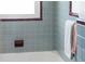 Traditional bathroom with vintage, gray tiled walls with a maroon-tiled trim at 222 N Clearview Ave, Tampa, FL 33609