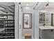Bright bathroom featuring floating vanity, lighted mirror, and access to closet at 222 N Clearview Ave, Tampa, FL 33609