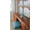 Bedroom with shelves and a floating desk with a blue stool at 222 N Clearview Ave, Tampa, FL 33609