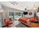Bright bedroom featuring a ceiling fan, sliding glass doors to pool, and stylish modern decor at 222 N Clearview Ave, Tampa, FL 33609