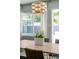Well-lit dining area with a modern chandelier and table centerpiece with tulips at 222 N Clearview Ave, Tampa, FL 33609