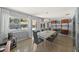 Dining room featuring a modern light fixture, refinished terrazzo floors, and backyard views of the pool at 222 N Clearview Ave, Tampa, FL 33609