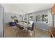Bright dining room showcasing a modern light fixture, refinished terrazzo floors, and views of the backyard at 222 N Clearview Ave, Tampa, FL 33609