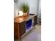 A vintage entertainment center converted into a stylish bar with illuminated glass storage at 222 N Clearview Ave, Tampa, FL 33609