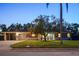 Traditional brick home with a well-kept lawn, mature tree, and inviting curb appeal at 222 N Clearview Ave, Tampa, FL 33609