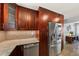 Modern kitchen featuring stainless steel appliances, granite countertops, and sleek custom cabinets at 222 N Clearview Ave, Tampa, FL 33609