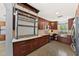 Spacious kitchen with stainless steel appliances and custom cabinetry and large metal rack at 222 N Clearview Ave, Tampa, FL 33609