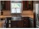 Modern kitchen features dark wood cabinetry, stainless steel appliances, and a farmhouse sink at 222 N Clearview Ave, Tampa, FL 33609