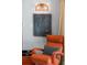 Comfortable lounge chair with throw pillow and unique mid-century modern artwork at 222 N Clearview Ave, Tampa, FL 33609