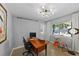 Bright office space with a large window overlooking the pool and backyard, plus a contemporary light fixture at 222 N Clearview Ave, Tampa, FL 33609