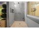An outdoor shower with modern fixtures, a tiled floor, and an adjacent privacy screen, all surrounded by greenery at 222 N Clearview Ave, Tampa, FL 33609