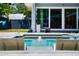 Relaxing backyard pool with lounge chairs and a view of the home's modern design at 222 N Clearview Ave, Tampa, FL 33609