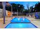 Backyard with an inviting pool, outdoor seating, and well-maintained landscaping in a fenced yard at 222 N Clearview Ave, Tampa, FL 33609