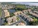 Picturesque aerial view highlighting the community layout with a pool, pond, and well-kept landscaping at 2527 Silverback Ct, Palm Harbor, FL 34684