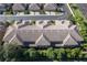Aerial view of multi-unit dwelling showcasing roof and surrounding landscape within a well maintained community at 2527 Silverback Ct, Palm Harbor, FL 34684