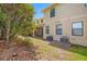 An outdoor shot features the backyard, showcasing the rear exterior of a house with a screened-in patio and air conditioning units at 2527 Silverback Ct, Palm Harbor, FL 34684