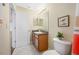 Bathroom featuring a vanity, framed mirror, neutral tile, and a colorful curtain at 2527 Silverback Ct, Palm Harbor, FL 34684