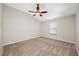 Cozy bedroom with vaulted ceiling, ceiling fan, plush carpeting, and a window for natural light at 2527 Silverback Ct, Palm Harbor, FL 34684