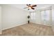 Bright bedroom with plush carpet, ceiling fan, and a neutral color scheme, move-in ready at 2527 Silverback Ct, Palm Harbor, FL 34684