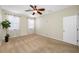 Bright bedroom featuring a ceiling fan and natural light streaming through the windows at 2527 Silverback Ct, Palm Harbor, FL 34684