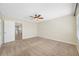 Bedroom featuring carpet flooring, a ceiling fan, and access to a landing at 2527 Silverback Ct, Palm Harbor, FL 34684