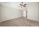Bright bedroom featuring neutral tones, carpet, and a ceiling fan at 2527 Silverback Ct, Palm Harbor, FL 34684