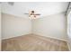Neutral bedroom with a ceiling fan and a large window at 2527 Silverback Ct, Palm Harbor, FL 34684